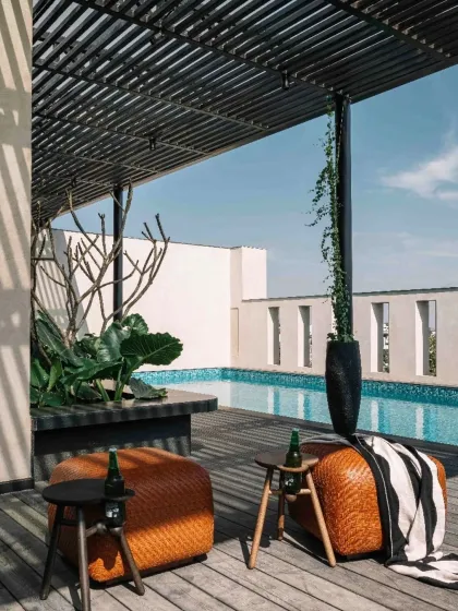 The rooftop terrace of Project 1374 is designed as a seamless extension of the home. A wooden deck, shaded pergola, and private pool create a tranquil entertainment zone where the interplay of raw, tactile surfaces and curated greenery continues to unfold.