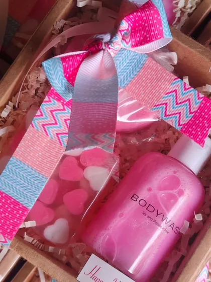 A close-up of the heart-themed Women's Day gift box, showing the detail of the soaps and the cheerful packaging.
