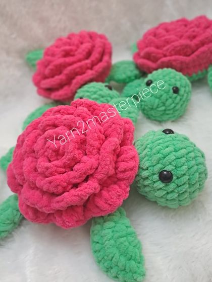 Another pair of the green and pink plush rose turtles.