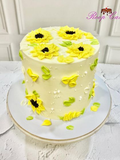 Sunflower vibes only. This cake is covered in bright yellow, hand-piped sunflowers, bringing a dose of sunshine to any celebration.