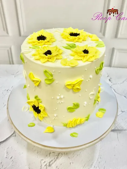 Sunflower vibes only. This cake is covered in bright yellow, hand-piped sunflowers, bringing a dose of sunshine to any celebration.