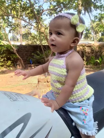 A candid shot of the Lavender Halter Top, paired with a matching bow headband. This set is perfect for a coordinated summer look.