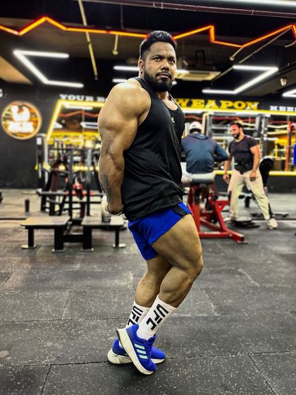 A side pose showing the leg and glute development. Power comes from the ground up.