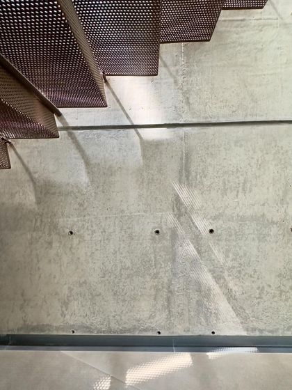 A detail of a perforated metal stair in the 'House of Stories', showing the shadow it casts.