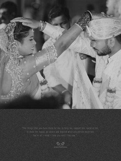 A powerful black and white image of a wedding ritual, capturing a moment of blessing and commitment.