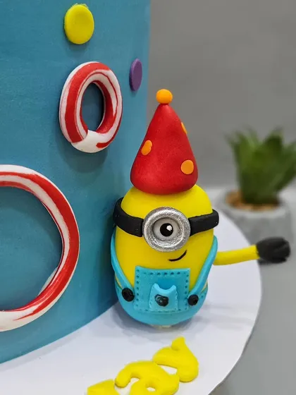 A close-up of a happy little Minion from a vibrant and colorful birthday cake. These character cakes are always a joy to make.