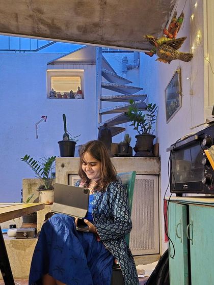 Vidya at work in the studio, deeply focused on her digital tablet. This captures the late nights and dedicated effort that went into the Playfield 1SR workshop.