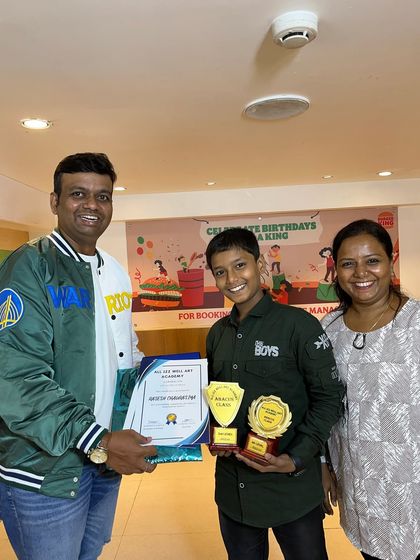 Rasesh, another dedicated student, proudly holds his awards for completing the 3rd and 4th levels of Abacus.