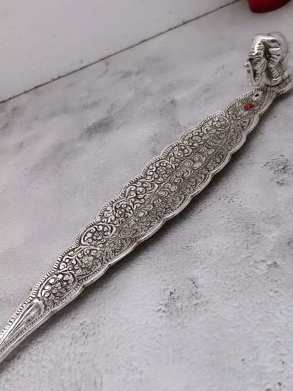 A German silver agarbatti or incense stick holder with an elephant motif. It collects the ash neatly while looking beautiful.