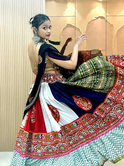 A side view showing the twirl of the lehenga and the intricate backless design of the choli. This outfit is designed to be admired from all angles.