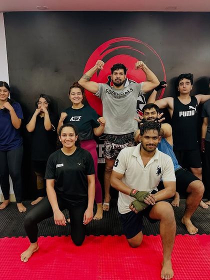 The evening batch with their coach, flexing and smiling after a great workout. This is what our community is all about.
