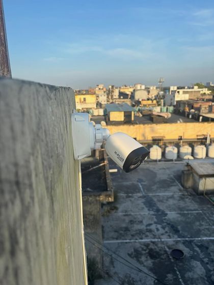 An outdoor bullet camera installed on a building in Ghitorni. This type of camera is excellent for monitoring large open areas like factory yards or building perimeters.