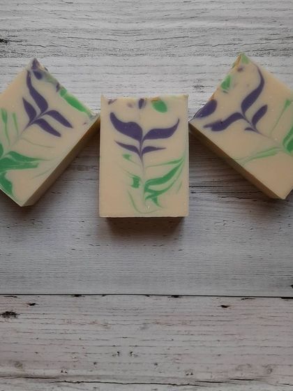 Three bars of my Blooming Lavender soap, showcasing the beautiful purple and green swirls. I make these with a special technique to mimic a lavender sprig, bringing a touch of the garden to your shower.