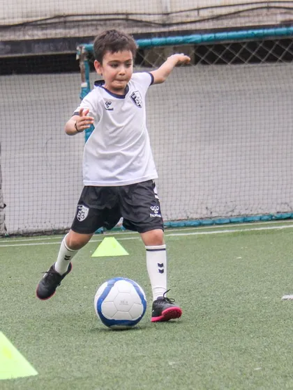 This player is about to strike the ball, showing the proper technique and body shape for a powerful and accurate shot.