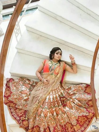 For the bride who wants to own her dream outfit, we offer heavily embellished bridal lehengas like this one. This piece features intricate, multi-colored threadwork and a classic silhouette, showing the kind of high-end couture you can find at our outlet.