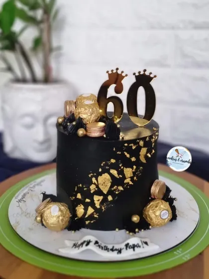 Celebrating a 60th birthday calls for something bold and elegant. This black and gold eggless cake, decorated with Ferrero Rocher chocolates and a custom topper, is a perfect example of a sophisticated design for a major milestone.