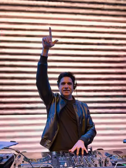 In the zone, feeling the pulse of the crowd. This is my happy place, behind the console, where I can connect with everyone and guide the energy of the night.