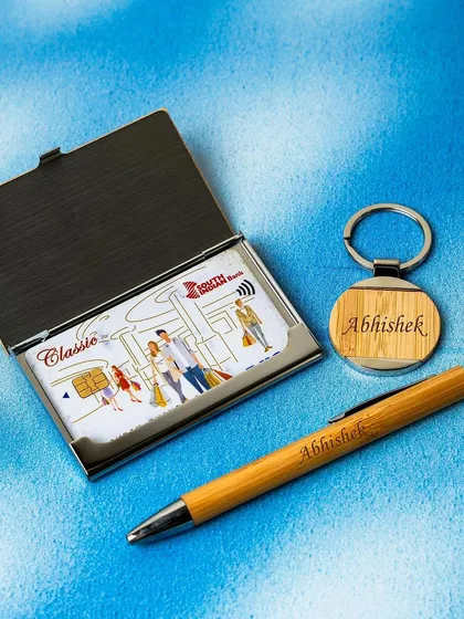 An eco-friendly and stylish gift set made from bamboo. This corporate gift includes a personalized bamboo card holder, pen, and keychain, all of which can be engraved with a name or logo.