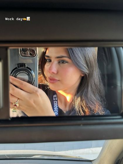 A creative selfie taken using the car's visor mirror. This is a unique and engaging way to capture a beauty look, showing my creative approach to content.