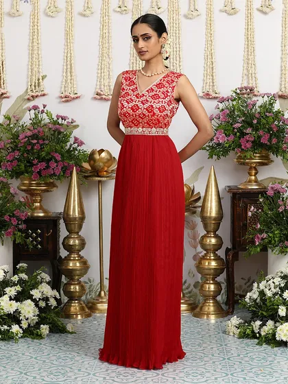 A standing pose that highlights the elegant silhouette of our red Bandhani gown.