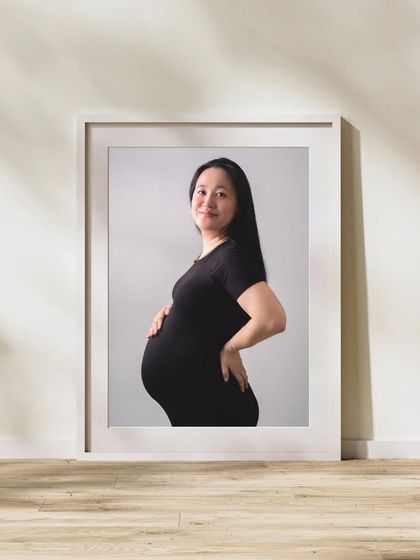 A portrait of a mother-to-be, framed and ready to become a cherished piece of home decor. I can help you choose the best images to print and display.