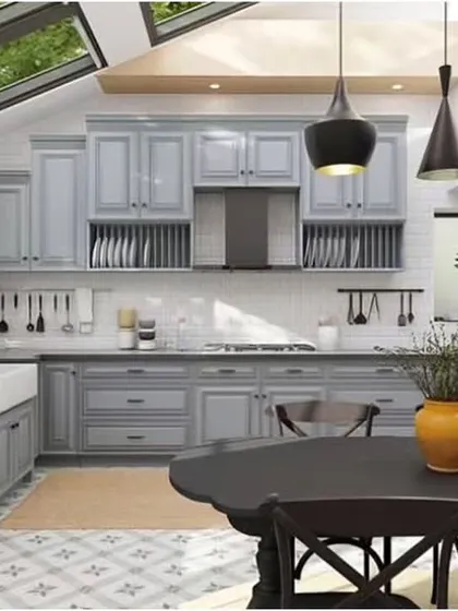 Natural light floods this classic U-shaped kitchen through large skylights, highlighting the soft grey cabinetry and patterned floor tiles. This design includes an integrated dining area, making it a functional and inviting space for the whole family.