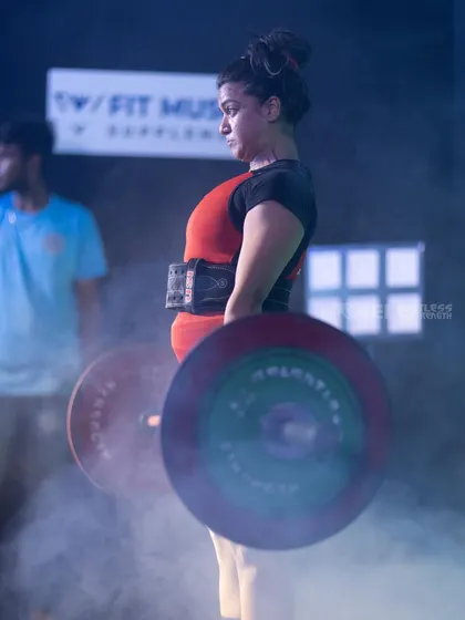 This is the kind of strength I help you build. A moment of pure focus and power during a deadlift at my first powerlifting competition. My coaching will guide you to master foundational lifts like this, focusing on proper form to build strength safely and effectively, whether you're a beginner or a seasoned lifter.