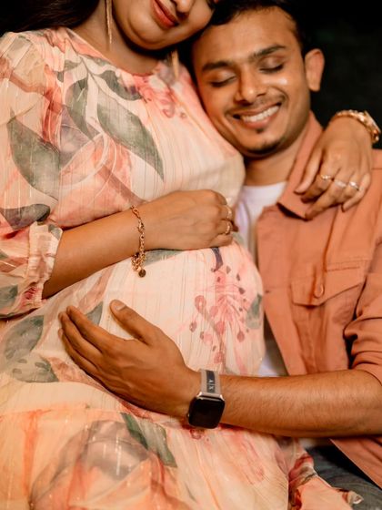 A detail-oriented maternity shot focusing on the couple's hands on the baby bump. This intimate perspective highlights the connection and anticipation for their new arrival.