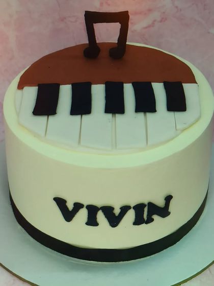 A classic vanilla piano cake for a music lover. The simple design features fondant keys and a music note.