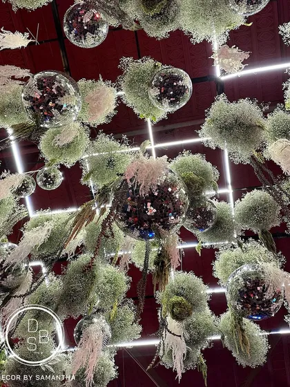 I love playing with ceilings to completely transform a space. This "Disco on the greens" installation combined lush florals with sparkling disco balls for a corporate celebration, proving that any event can have a touch of magic.