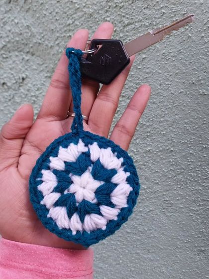 A mandala keychain with a loop for easy attachment to your keys. A lovely, detailed piece.