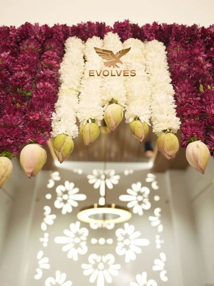 A detailed shot of the top portion of the door decor, highlighting the lotus buds and dense floral work.