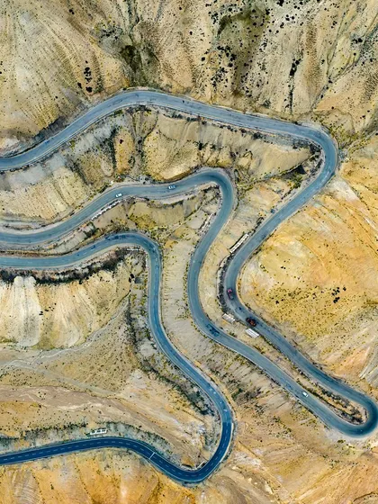 The roads in Ladakh are like arteries on the land, each turn telling a story of a journey. This top-down shot of the winding mountain roads shows the beautiful, abstract patterns nature and man create together. It's a perspective you can only truly appreciate from the sky.
