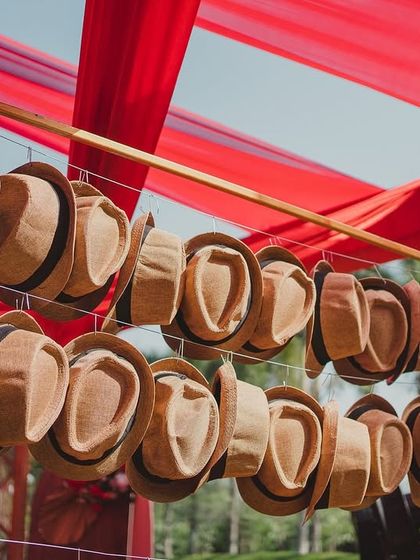 To complete the Spanish fiesta look, we hung rows of straw fedora hats for guests to wear, adding an interactive and stylish element to the day.
