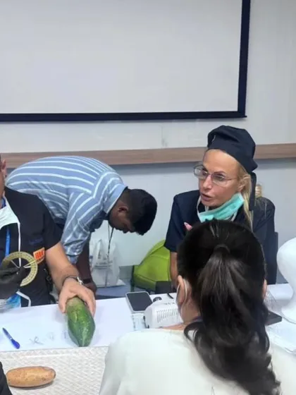Practicing on models is a key first step. Here, faculty demonstrates techniques on simulation models before moving to live patients.