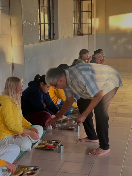 Another angle of serving the Sadya feast. The act of serving and eating together on the floor fosters a sense of equality and community.