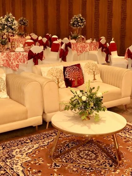 A comfortable lounge area for guests, with plush cream sofas, cushions featuring the 'tree of life' motif, and a beautiful Persian rug.