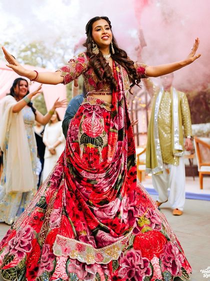 The bride's solo performance, her arms outstretched as she dances with joy and grace.