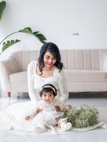 A mother and daughter sitting together in the studio.
