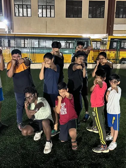 This is our team, our family. A group of our summer camp boxers posing after a tough session. We train hard together and support each other, creating a positive and motivating environment for everyone.