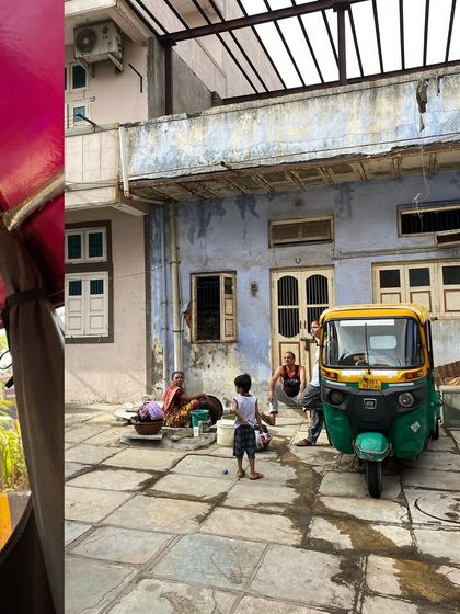 A candid family moment in a courtyard, a quiet slice of life away from the main street's hustle.