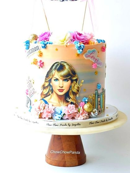 A cake I designed for a Taylor Swift fan. This rainbow-flavoured cake features an edible print of the artist and is decorated with details from her album eras.