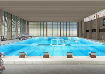 The interior of the Olympic-sized swimming pool within the Sports Block. High ceilings and extensive glazing create a bright and spacious environment for athletes.