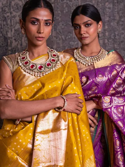Our models showcase two distinct bridal looks: a vibrant yellow Kanchipuram with polka dots and a royal purple brocade, both perfect for different wedding functions.