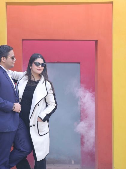 A romantic couple's portrait using our colorful wall backdrop and a smoke effect to add a touch of magic to their pre-wedding photoshoot.