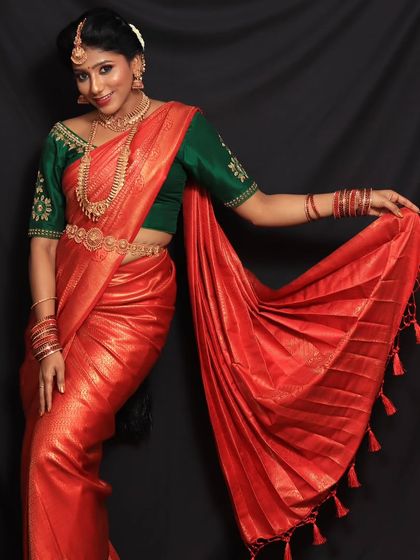 This client wanted a powerful and striking look for her photoshoot. The vibrant red saree with its perfectly fanned pleats helped create just that.