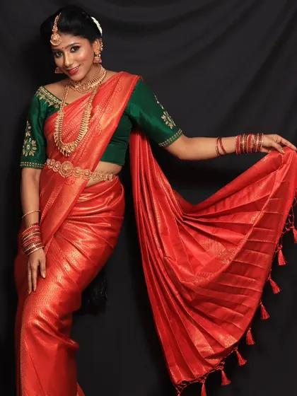 This client wanted a powerful and striking look for her photoshoot. The vibrant red saree with its perfectly fanned pleats helped create just that.