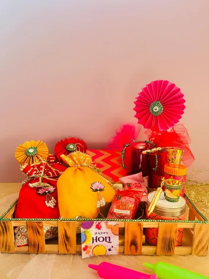 This wooden crate hamper is filled with a rainbow of Holi essentials. It includes colorful potlis, organic gulal, and festive decorations, all ready for a joyous celebration.