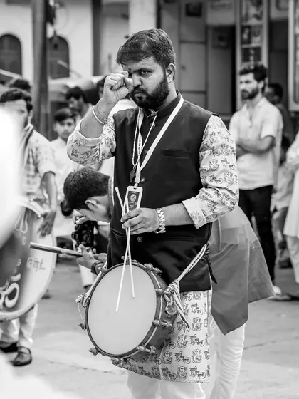 A black and white portrait of a tasha player, his expression showing his 'rubab' or swag.