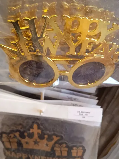 Shiny gold 'Happy New Year' glasses. These are a classic party favor that everyone will love to wear as the clock strikes midnight.